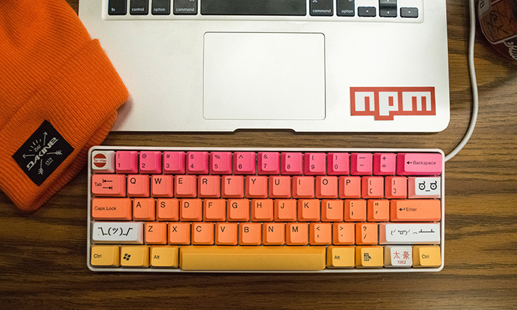 A desktop with a keyboard and a knitted beanie